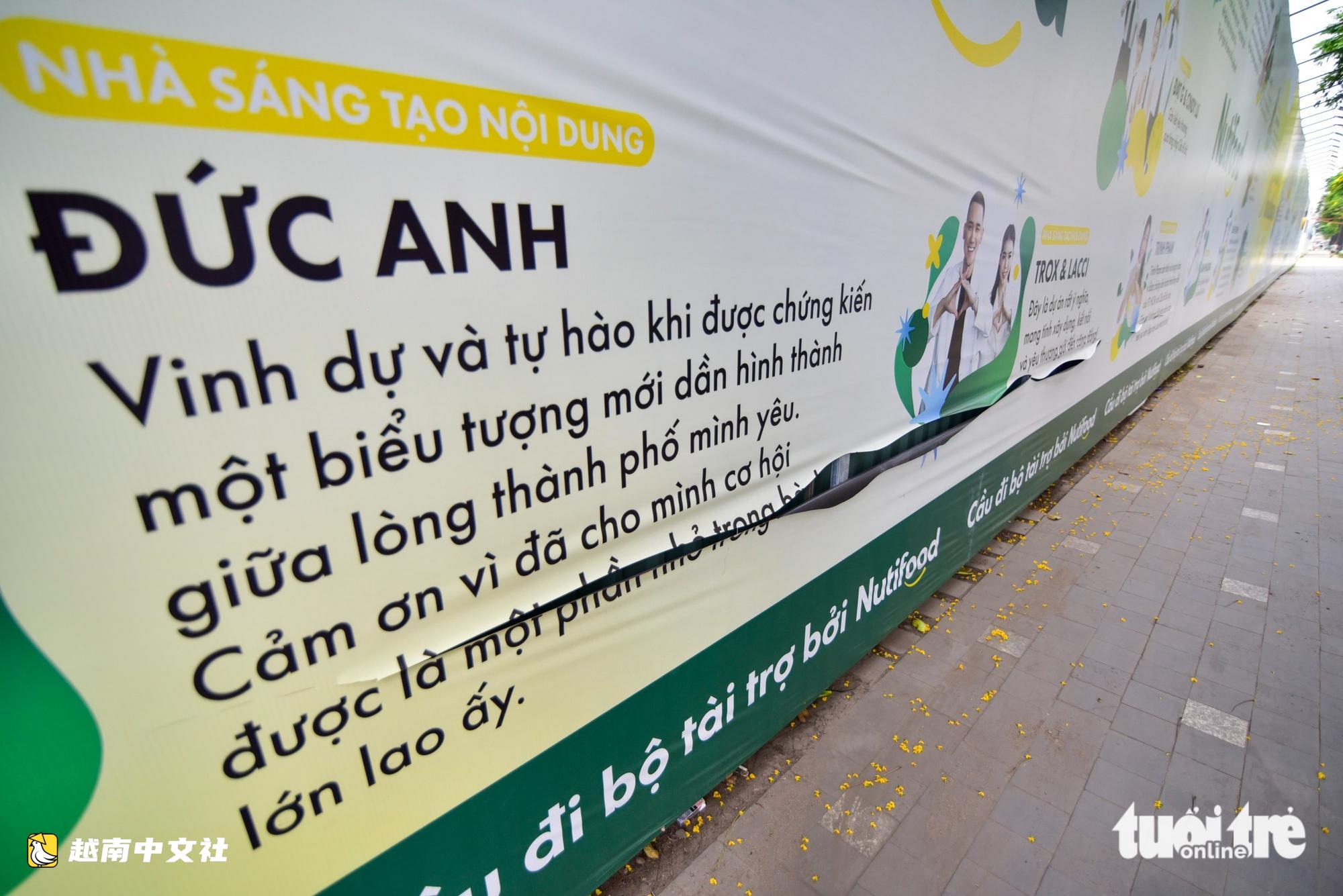 胡志明市西貢河上萬億越盾人行橋工地的圍欄屢遭塗鴉和割破