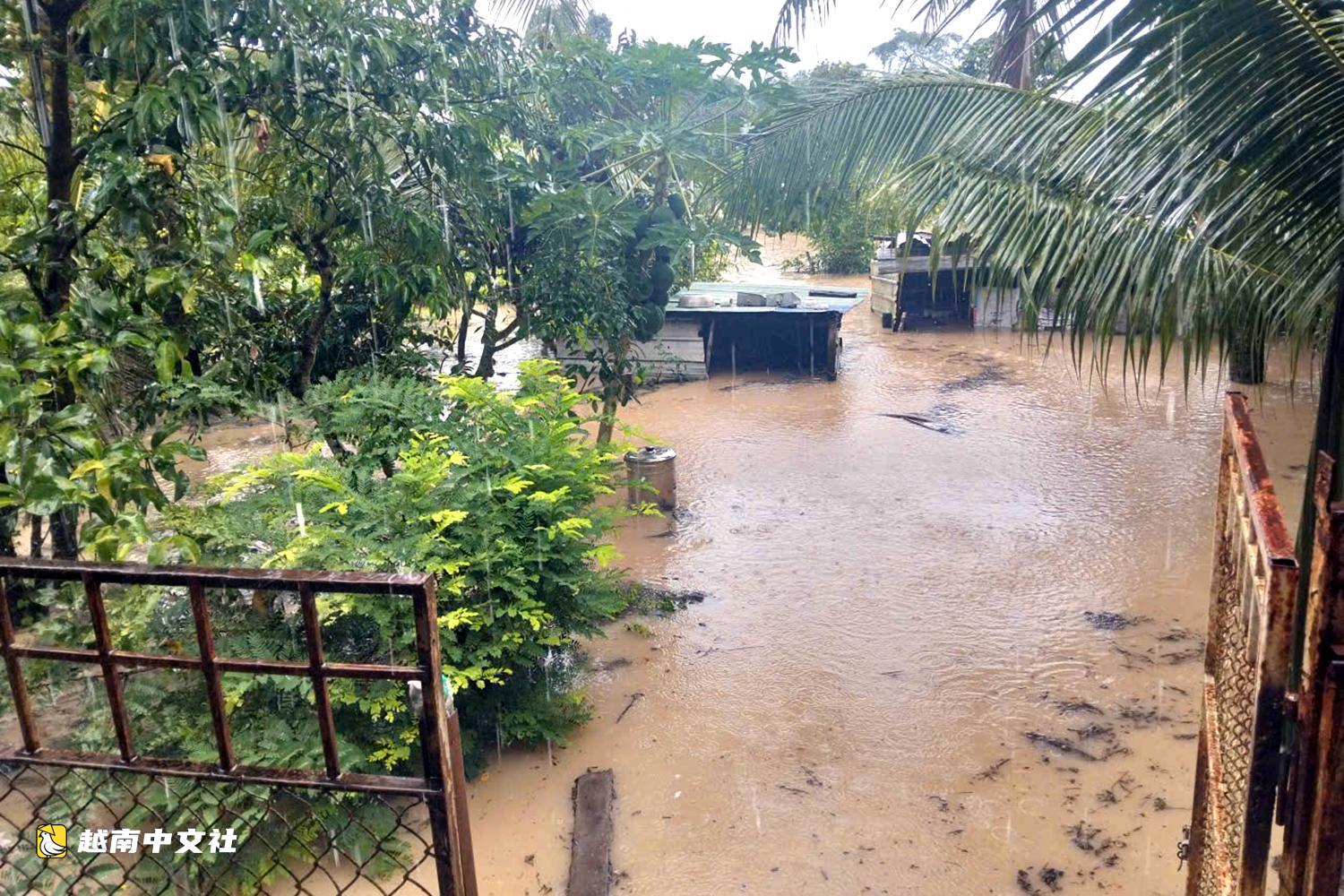 越南同奈大雨漲潮,民眾清晨蹚水上班