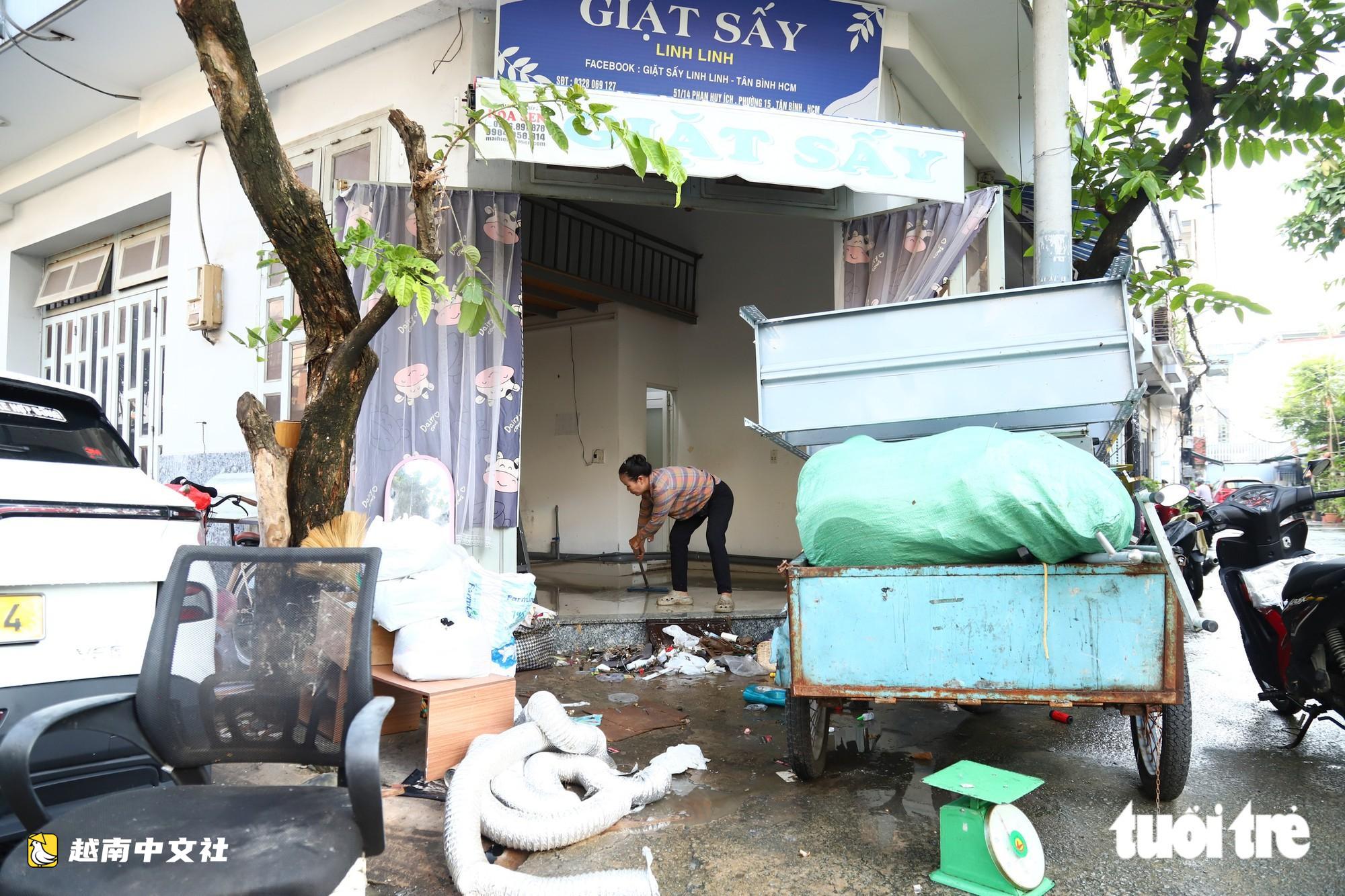 越南胡志明市創紀錄暴雨內澇後,潘輝益路積水退去,居民忙著清理家園