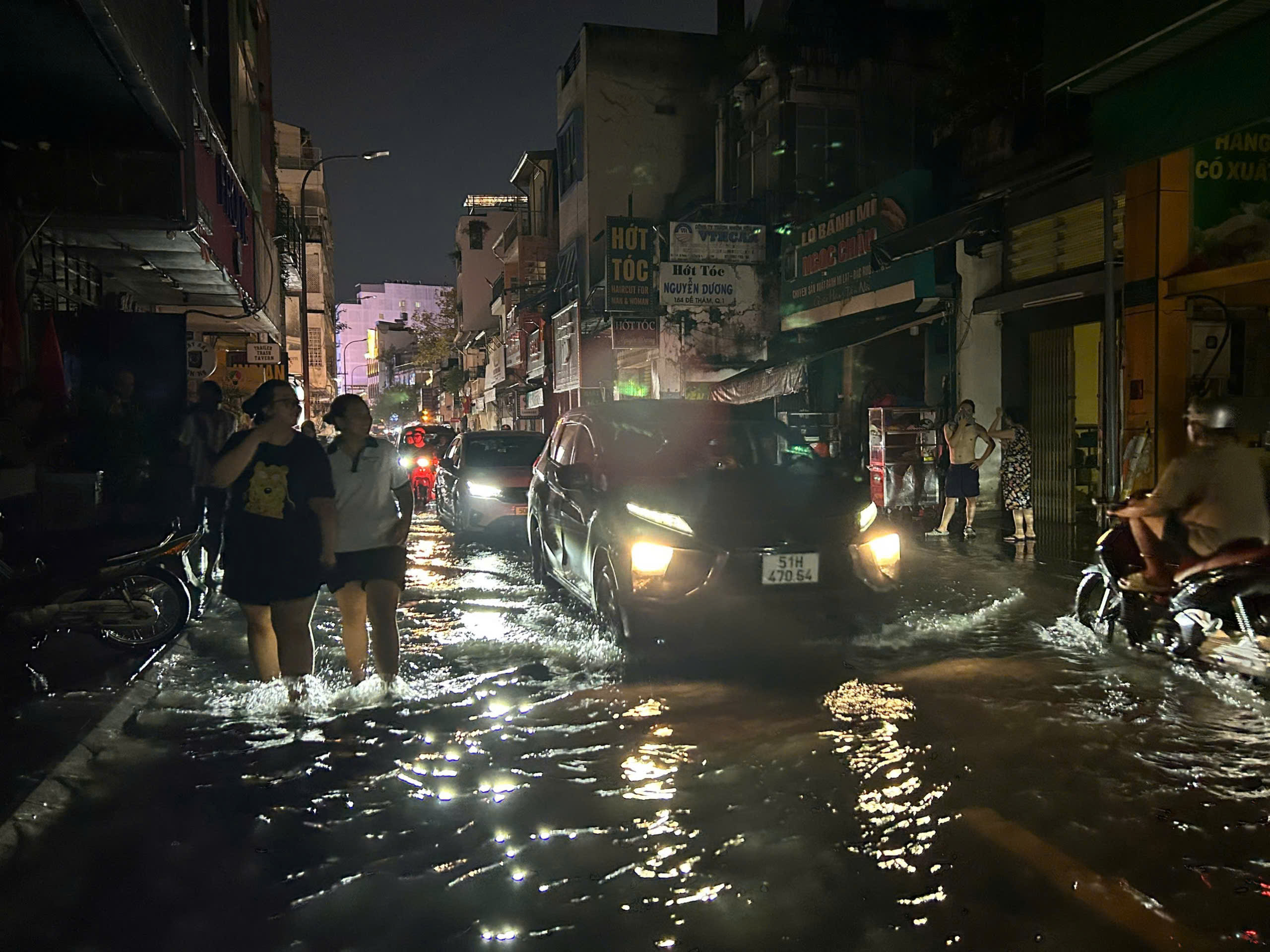 胡志明市中心大雨后严重积水，行人疑因居民房屋裸露接头触电