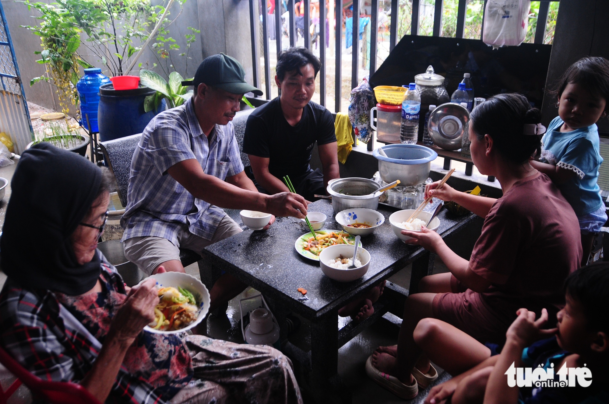 洪水肆虐地区居民伴着雨水和泪水的简单餐食