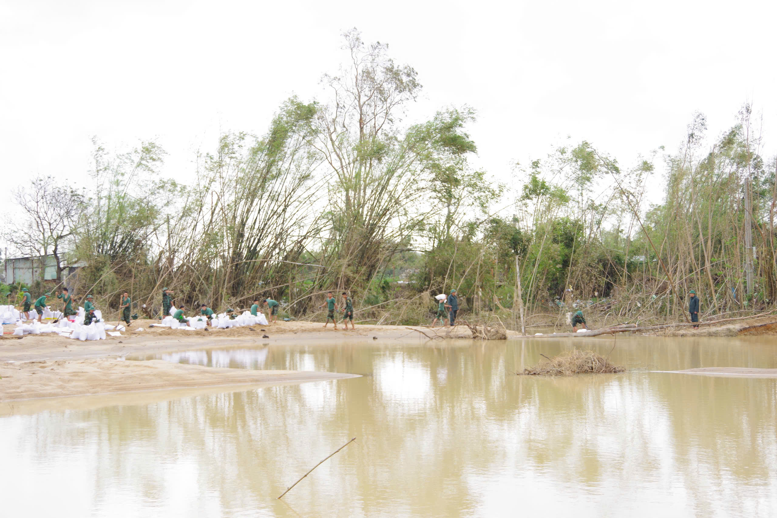 嘉莱省100多名士兵与地方力量用沙袋修补决堤段