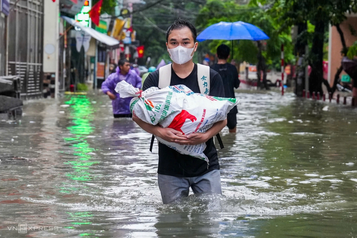 居民在桥下避雨，涉水寻找回家路