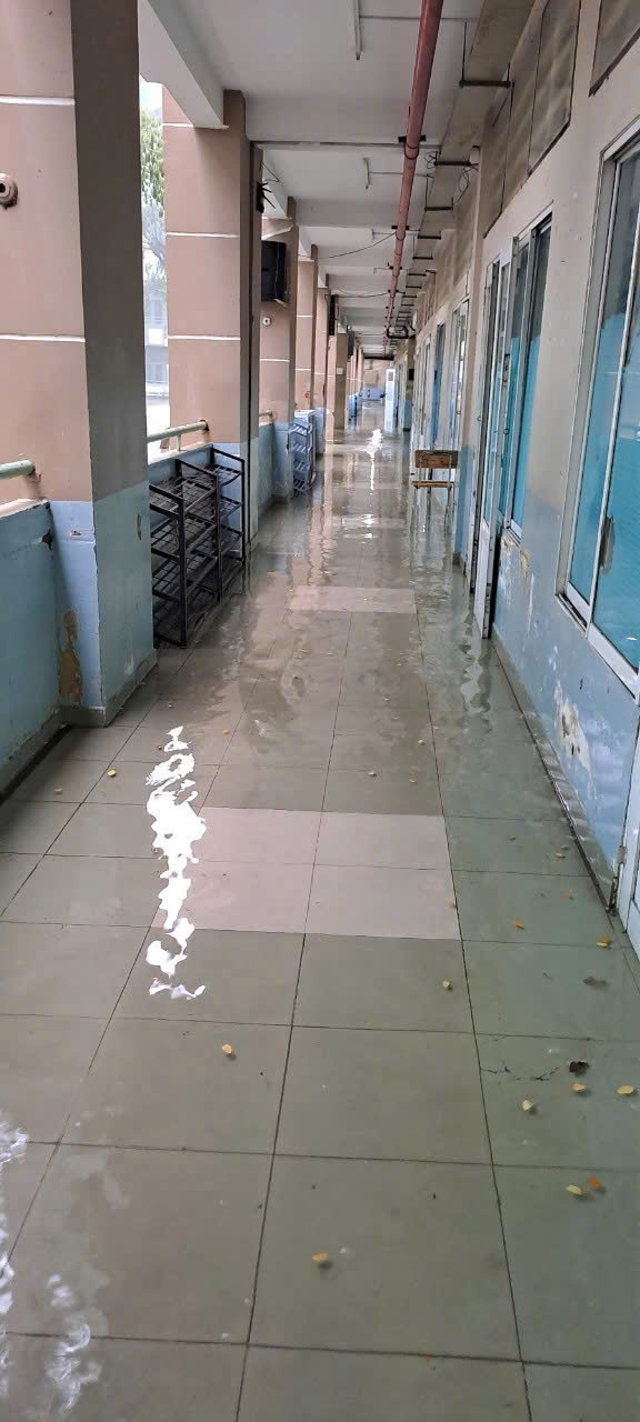 胡志明市一所学校每逢大雨就积水，老师们必须舀水